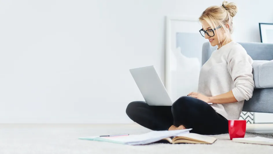 Woman sitting on floor with laptop