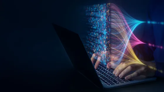 Image of person's hands typing on a laptop